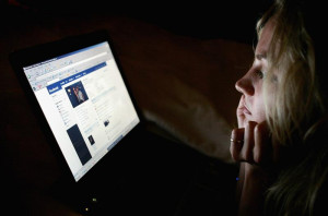 girl in London looks at a page on Facebook. Studies have shown that ...
