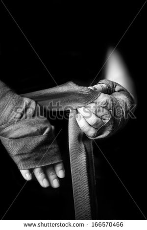 Woman wrapping her hands for kickboxing. - stock photo