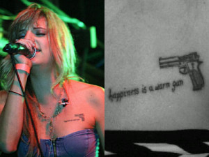 On her left arm is a heart pierced by a dagger. There is a ribbon ...