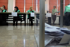 Completed ballots pile up in a transparent box at a polling station in ...