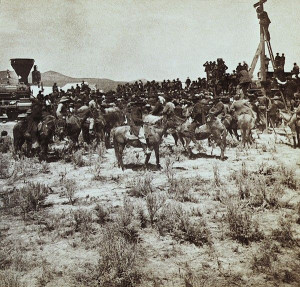 Transcontinental Railroad celebration. Horsemen, engineers and workers ...