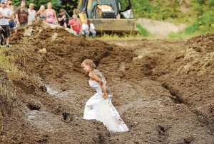 Lucretia (Blais) Gould walks through the mud run pit in her wedding ...
