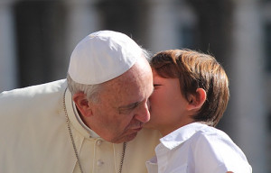 Pope Francis greets a young pilgrim in St. Peter's Square before the ...