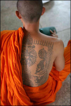 ... meditates while tattoos are inked onto a long line of devotees