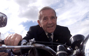 Sir Norman Wisdom tests a 1952 AJS 500cc motorcycle at Goodwood in ...