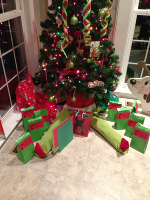 having the Grinch conspicuously hiding beneath the tree with a quote ...