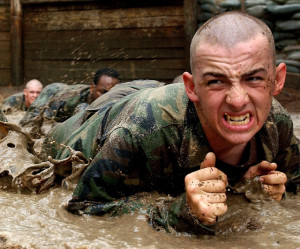 the mud on an obstacle course during Army Basic Combat Training ...