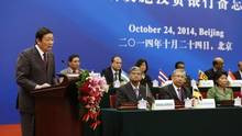 China's Finance Minister Lou Jiwei (L) gives a speech, with the guests ...