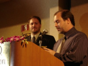 John Everson accepts the First Novel award from president Joe Nassise