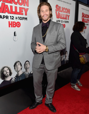 TJ Miller brings humor to the red carpet accessorizing with a gold