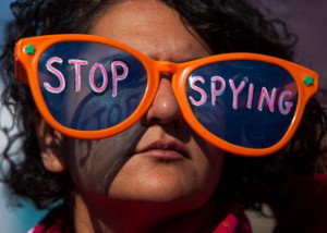 wearing oversized sunglasses lettered with the words 'stop spying ...