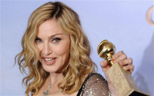 Madonna at the 2012 Golden Globes awards with her gong for Best Song ...