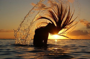Beautiful hair flip in the water background sun set
