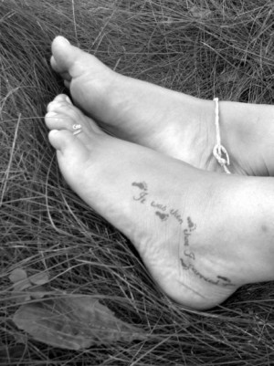 Footprints in the sand foot tattoo .