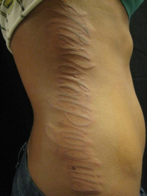 home side body art scars writing tattoo on side body