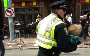 ... officer carries a child to safety after the Boston Marathon bombings