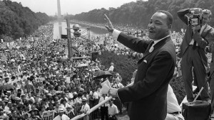 Civil rights leader Martin Luther King Jr. (C) waves to supporters ...