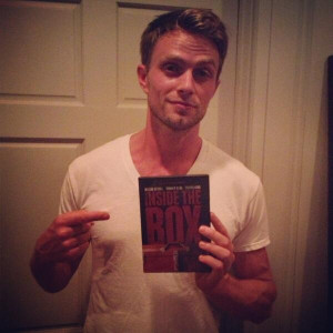 Wilson Bethel holding his copy of 'Inside The Box' DVD;