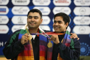 Gagan Narang, left, and Hasan Imran Khan smile with the gold medals ...