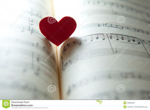 Love for music. heart shape on a music note book. shallow DOF.