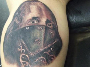... scarf hides the mouth of the man, in this realistically shaded tattoo