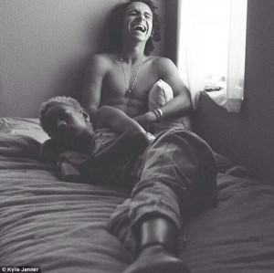 ... as she is pictured lying in bed with 20-year-old actor Moises Arias