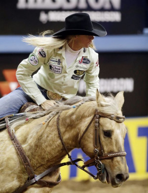 Sherry Cervi rides in the barrel racing competition during the tenth ...