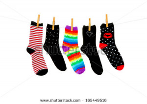 Odd socks whose mates have been lost, hanging on a clothesline. Shot ...
