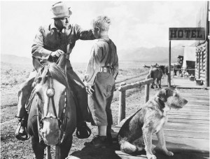 Shane (Alan Ladd) has trouble leaving behind little Joey .