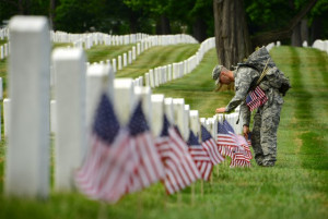 American flag in front of a gravestone in Arlington National Cemetery ...