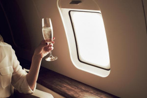 100424618-private-jet-relaxing-woman-champagne-gettyp.600x400.jpg