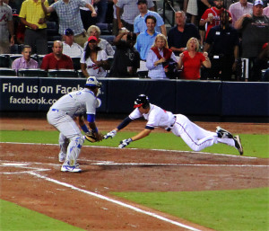 Atlanta Braves player airborne before getting out