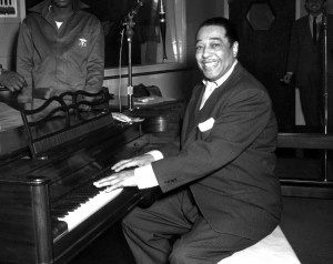 Duke Ellington, a famous jazz musician, poses with his piano at the ...