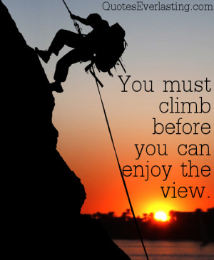 rock climber at sunset time going up a mountain