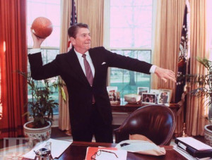 President Reagan tosses the football in the Oval Office