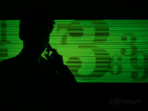 Businessman on a Cell Phone as Stock Quotes Scroll By Fotografie-Druck