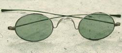 Saddle bridge spectacles with dark grey lenses, circa 1890