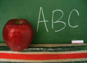 Apple sitting on the ledge of a blackboard
