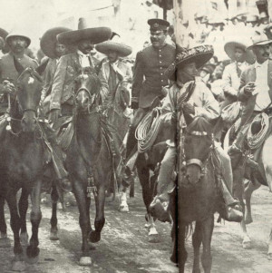 ... jacket) and Pancho Villa (in uniform) ride into Mexico City in 1914