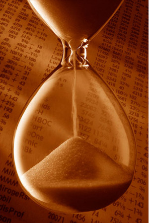 hourglass in front of stock quotes