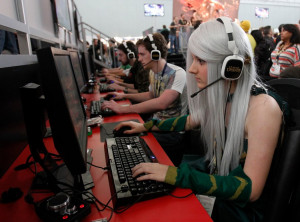 group of people playing League of Legends at a gaming conference in ...