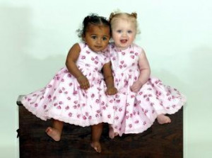 ... : Photographs show a pair of black and white fraternal twin girls