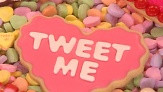 ... makes sugar cookie hearts topped with sweet Valentine's Day sayings