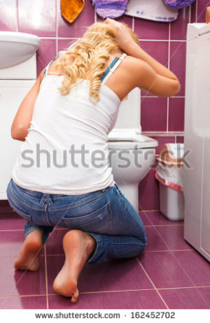 Hangover after party, woman in the toilet - stock photo