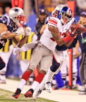Mario Manningham makes a catch as New England Patriots free safety ...