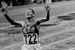 Billy Mills pulls off a stunning upset by winning the 10 000 meters