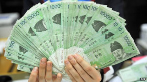 ... holding South Korean won banknotes at the Korea Exchange Bank in Seoul