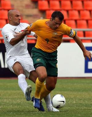 ... tokeep Mark Viduka from getting away from him last night. PICTURE:AFP