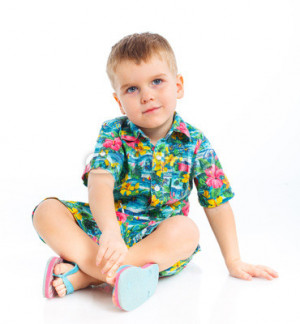 Photo: Little cute boy dressed in beach clothes