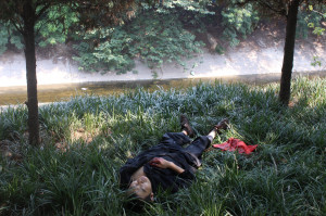 Chinese man lying on a riverbank after having attempted to commit ...